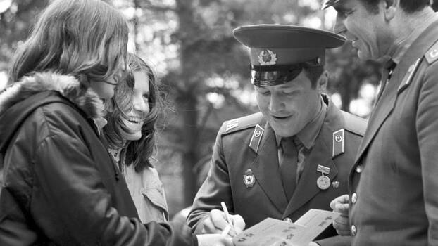 Two Soviet soldiers and two young East German women at a friendship meeting in 1974.